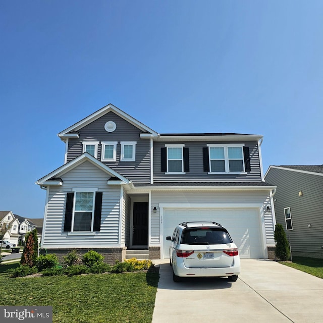 106 Poe Dr, Winchester, VA 22602 - view of front facade featuring concrete driveway, a garage, a front yard, and brick siding