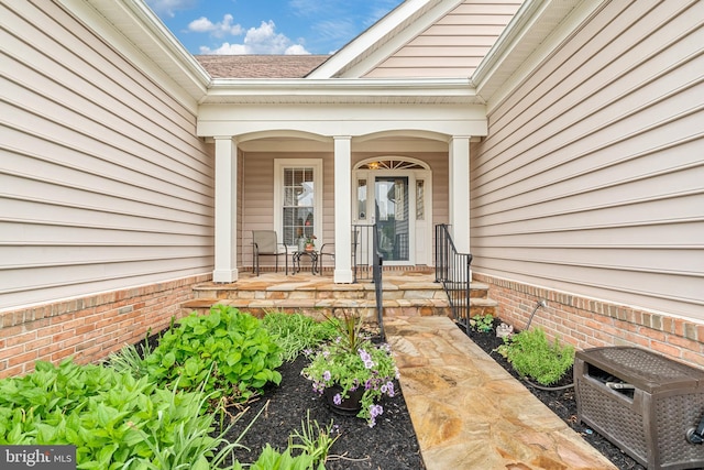 6051 Piney Grove Way, Gainesville, VA 20155 - view of exterior entry featuring covered porch and a shingled roof