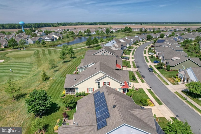 aerial view of residential area featuring a large body of water and a golf course