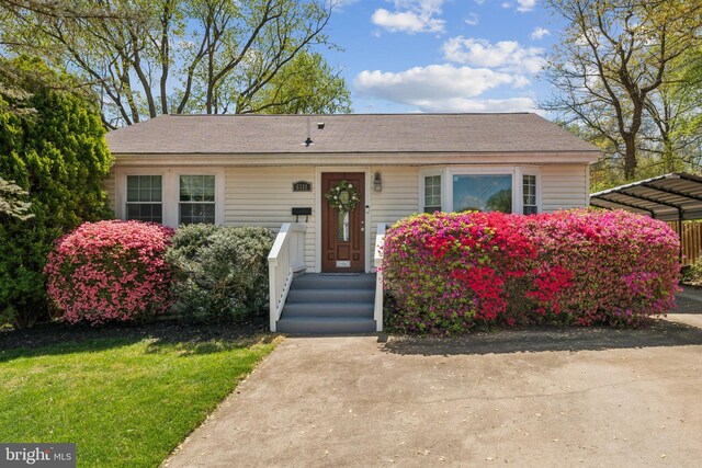 6311 Gentele Ct, Alexandria, VA 22310 - view of front of property featuring a detached carport, a front yard, and a shingled roof