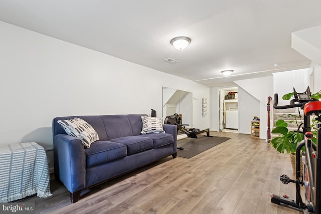 6311 Gentele Ct, Alexandria, VA 22310 - living area with light wood-type flooring and washer / dryer