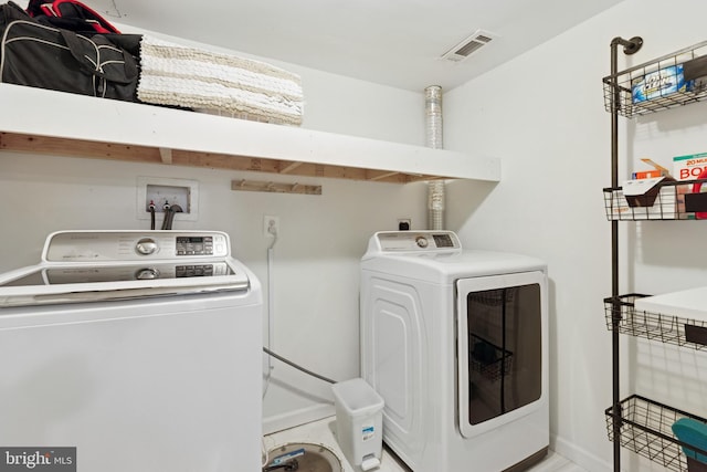 6311 Gentele Ct, Alexandria, VA 22310 - clothes washing area with washing machine and dryer and baseboards