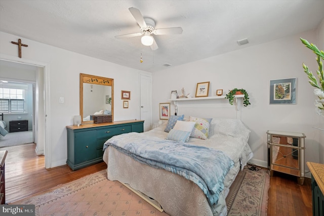 bedroom featuring hardwood / wood-style floors, ceiling fan, and baseboards