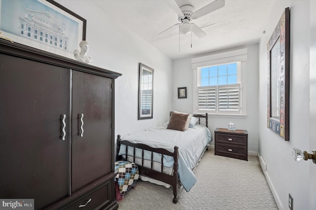 bedroom with light carpet, baseboards, and a ceiling fan