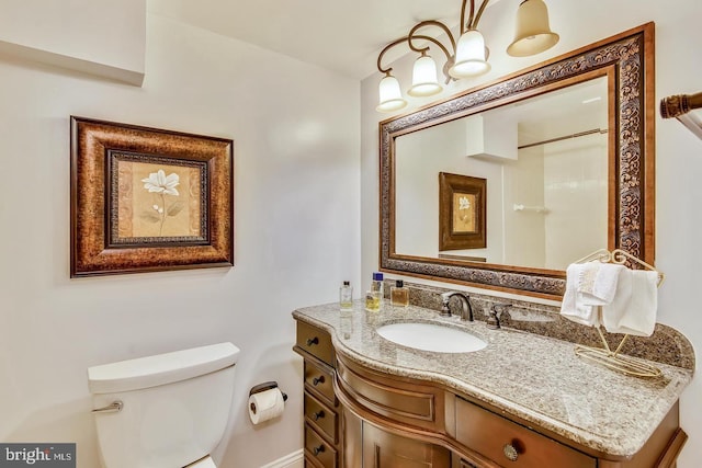 bathroom with toilet and vanity