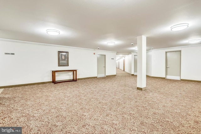 finished below grade area featuring carpet, crown molding, and baseboards