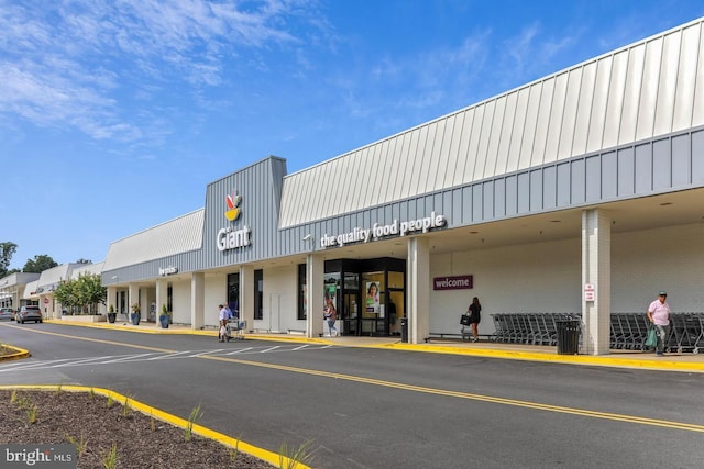 view of building exterior with uncovered parking