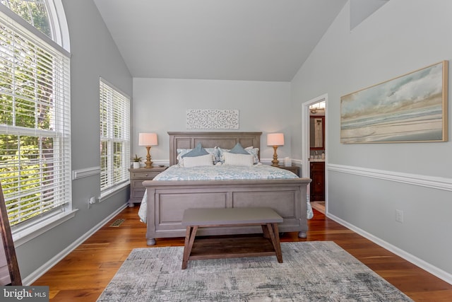 bedroom featuring high vaulted ceiling, wood finished floors, and baseboards