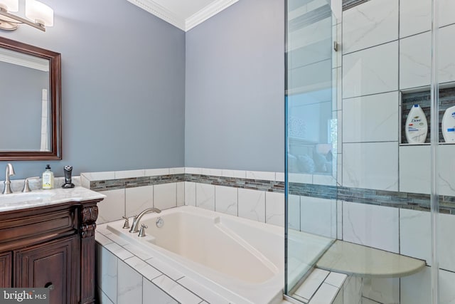 full bathroom featuring crown molding, a garden tub, and vanity