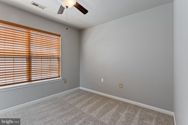 empty room featuring a ceiling fan, carpet flooring, and baseboards