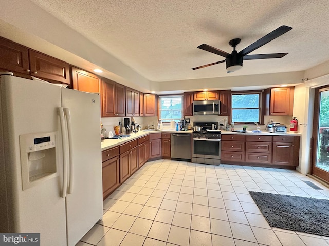 2315 Ilene Ln, Atco, NJ 08004 - kitchen featuring appliances with stainless steel finishes, a textured ceiling, ceiling fan, light tile patterned flooring, and light countertops