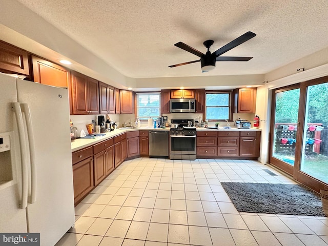 2315 Ilene Ln, Atco, NJ 08004 - kitchen with stainless steel appliances, ceiling fan, a textured ceiling, light countertops, and light tile patterned floors