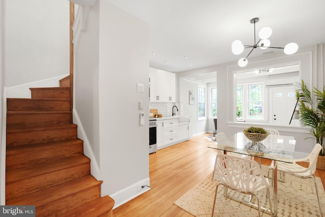 2420 2nd St NE, Washington, DC 20002 - dining area featuring stairs, a chandelier, light wood-style flooring, baseboards, and recessed lighting