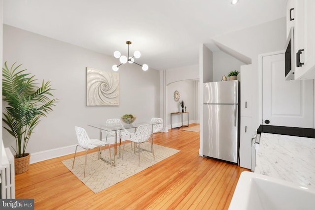 2420 2nd St NE, Washington, DC 20002 - dining space with a chandelier, light wood-style flooring, and baseboards