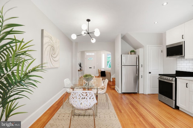 2420 2nd St NE, Washington, DC 20002 - dining area featuring arched walkways, light wood-type flooring, baseboards, a chandelier, and recessed lighting