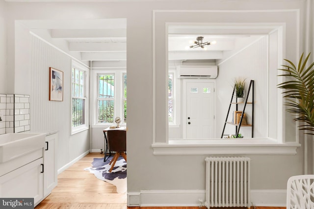 2420 2nd St NE, Washington, DC 20002 - entrance foyer with radiator heating unit, light wood finished floors, a wall mounted air conditioner, beamed ceiling, and baseboards