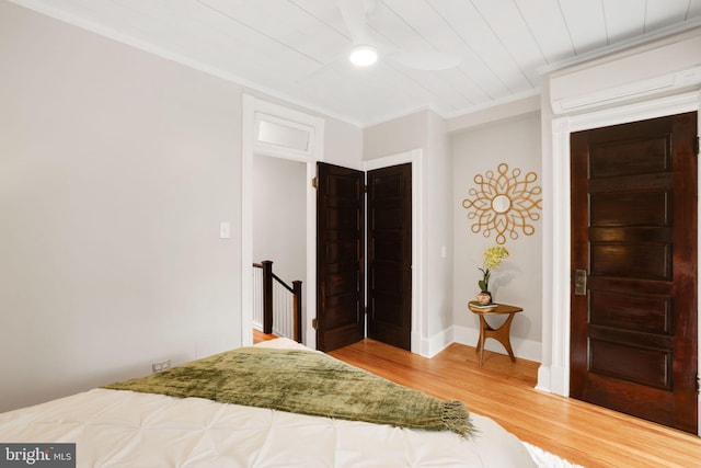 2420 2nd St NE, Washington, DC 20002 - bedroom featuring a wall unit AC, wood finished floors, ornamental molding, and baseboards