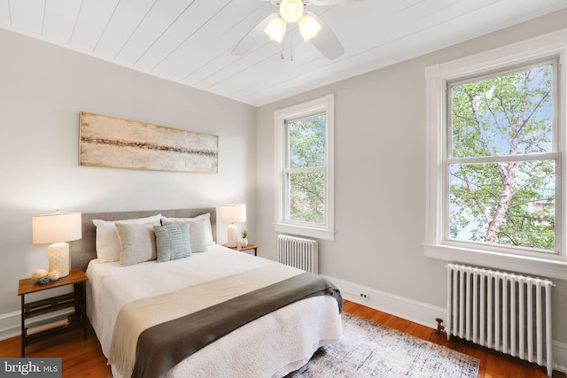 2420 2nd St NE, Washington, DC 20002 - bedroom featuring radiator, multiple windows, wood finished floors, and wood ceiling