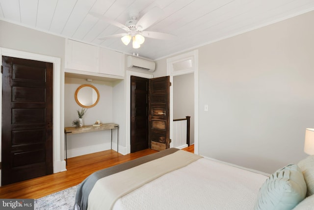 2420 2nd St NE, Washington, DC 20002 - bedroom featuring an AC wall unit, wood finished floors, baseboards, and ceiling fan