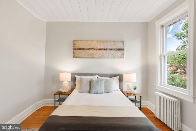 2420 2nd St NE, Washington, DC 20002 - bedroom with radiator heating unit, wood finished floors, baseboards, ornamental molding, and wood ceiling