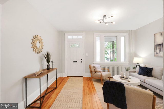 2420 2nd St NE, Washington, DC 20002 - living room with radiator, wood finished floors, a chandelier, and baseboards