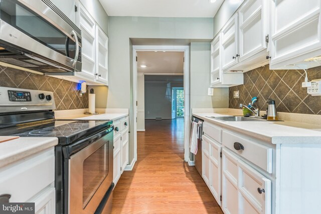 1509 Carlyle Dr Unit 152, Crofton, MD 21114 - kitchen with stainless steel appliances, white cabinets, light wood finished floors, backsplash, and recessed lighting