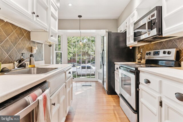 1509 Carlyle Dr Unit 152, Crofton, MD 21114 - kitchen with appliances with stainless steel finishes, decorative backsplash, white cabinets, a sink, and recessed lighting