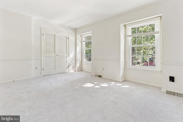 1509 Carlyle Dr Unit 152, Crofton, MD 21114 - unfurnished bedroom featuring multiple windows, carpet floors, ornamental molding, and baseboards