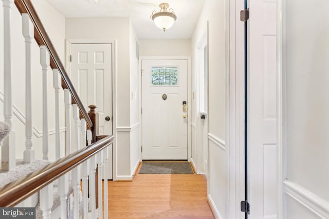 1509 Carlyle Dr Unit 152, Crofton, MD 21114 - doorway featuring light wood-style floors, stairway, a decorative wall, and a wainscoted wall