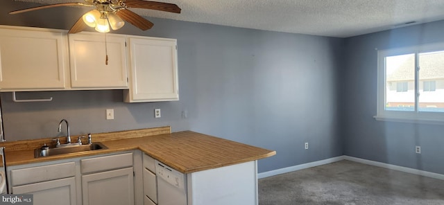 149 Captains Quarters Rd Unit 20102, Ocean City, MD 21842 - kitchen featuring a sink, white cabinets, a peninsula, a textured ceiling, and ceiling fan