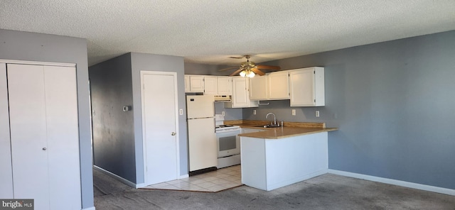 149 Captains Quarters Rd Unit 20102, Ocean City, MD 21842 - kitchen featuring a sink, white appliances, a peninsula, white cabinetry, and ceiling fan