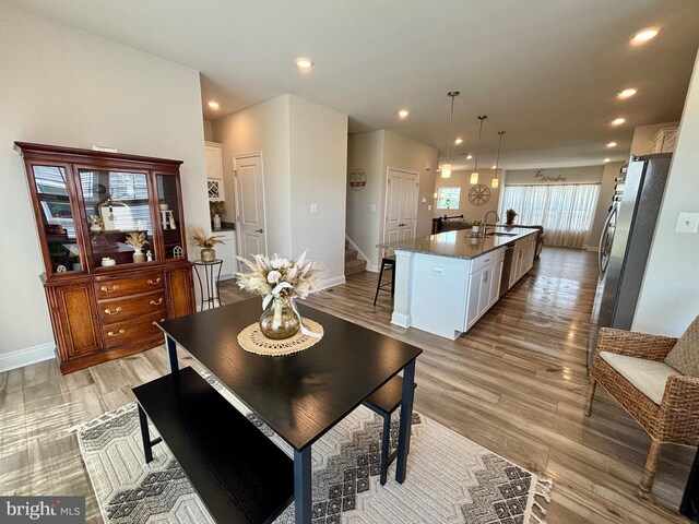 35342 Wright Way, Millsboro, DE 19966 - dining area featuring stairs, light wood-type flooring, baseboards, and recessed lighting