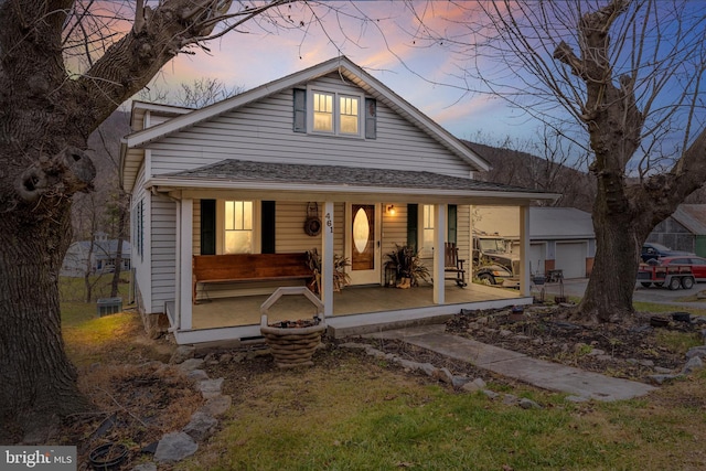 rear view of property featuring a porch