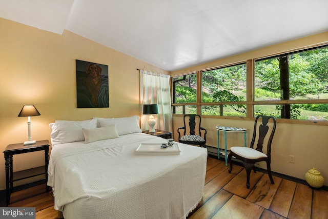 bedroom with hardwood / wood-style flooring and vaulted ceiling