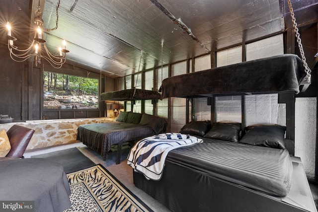 carpeted bedroom featuring a chandelier and vaulted ceiling
