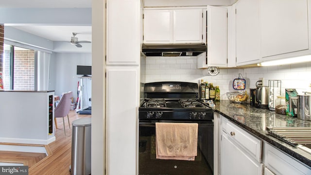 kitchen with black gas range, under cabinet range hood, a ceiling fan, and white cabinetry