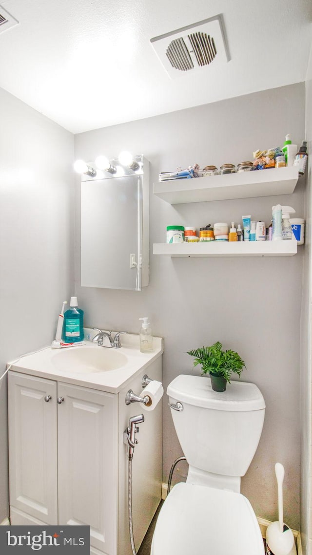 half bathroom with toilet and vanity
