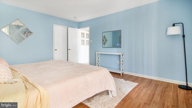 bedroom with wood finished floors and baseboards