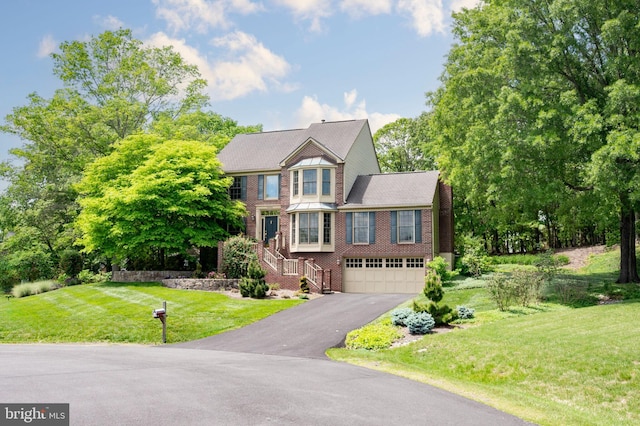 15069 Brown Post Ln, Centreville, VA 20121 - view of front facade with driveway, a garage, brick siding, stairway, and a front lawn