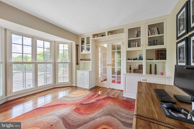 15069 Brown Post Ln, Centreville, VA 20121 - doorway to outside with french doors, wood finished floors, an office area, and built in shelves