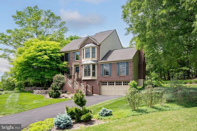 15069 Brown Post Ln, Centreville, VA 20121 - view of front of property featuring driveway, stairs, a garage, brick siding, and a front lawn