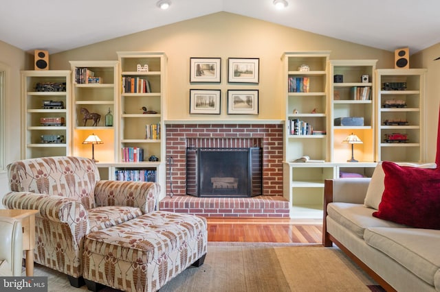 15069 Brown Post Ln, Centreville, VA 20121 - living room featuring vaulted ceiling, a brick fireplace, and wood finished floors