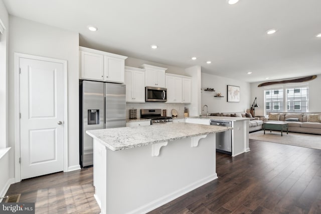 16 Foundry Blvd, Mount Holly, NJ 08060 - kitchen with stainless steel appliances, a kitchen island, a peninsula, dark wood-style flooring, and white cabinetry