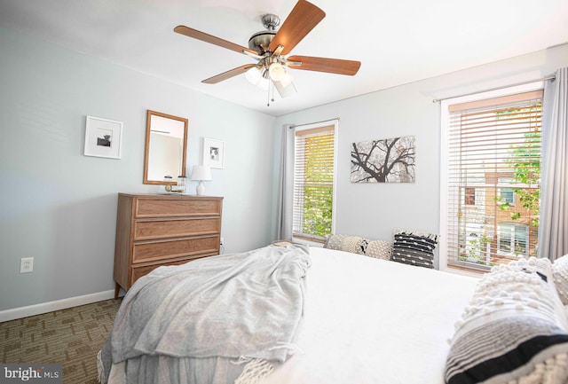 3211 Leverton Ave, Baltimore, MD 21224 - carpeted bedroom with multiple windows, baseboards, and ceiling fan