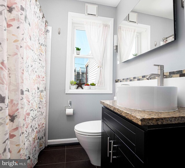 3211 Leverton Ave, Baltimore, MD 21224 - bathroom featuring tile patterned floors, vanity, toilet, baseboards, and a shower with shower curtain