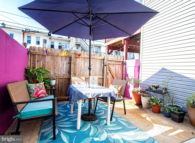 3211 Leverton Ave, Baltimore, MD 21224 - view of patio with a gate, fence, and outdoor dining area
