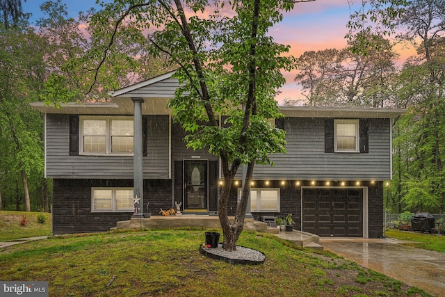 184 Chatham St, Pemberton, NJ 08015 - bi-level home featuring a garage, driveway, brick siding, and a front lawn