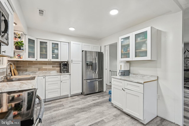184 Chatham St, Pemberton, NJ 08015 - kitchen with stainless steel appliances, a sink, white cabinets, light wood-style flooring, and light stone countertops