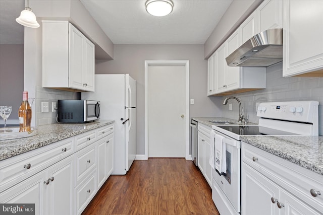 kitchen with appliances with stainless steel finishes, extractor fan, a sink, white cabinets, and tasteful backsplash