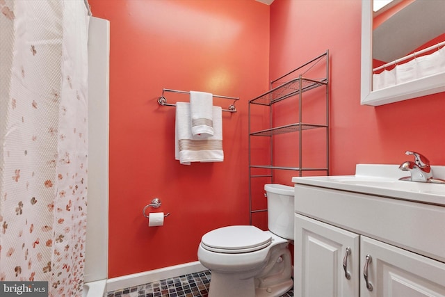 bathroom featuring vanity, toilet, baseboards, and a shower with shower curtain